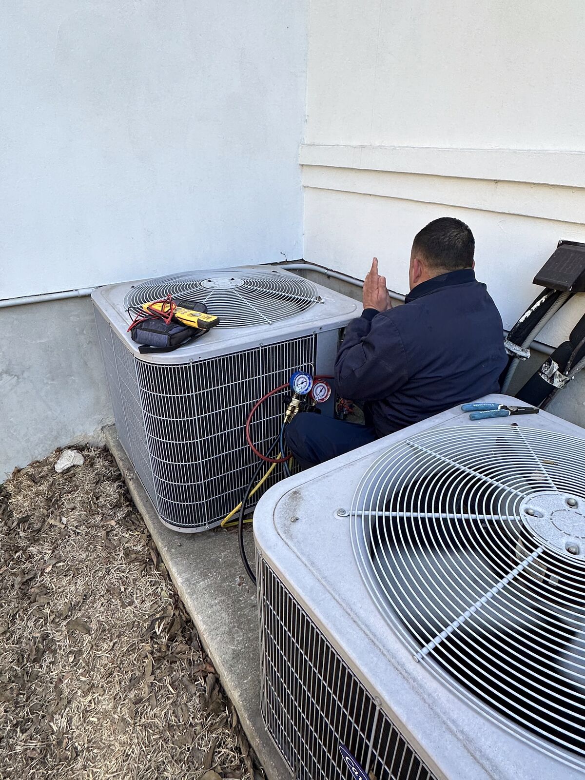 Comfort Heroes technician servicing residential AC condensers